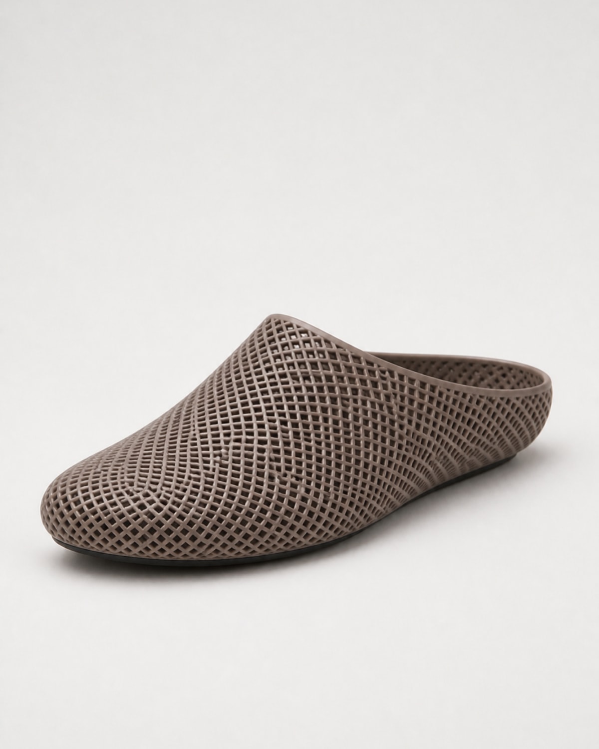 A single taupe-brown mesh slip-on mule shoe with a pointed toe, shown from a three-quarters angle on a light gray background.