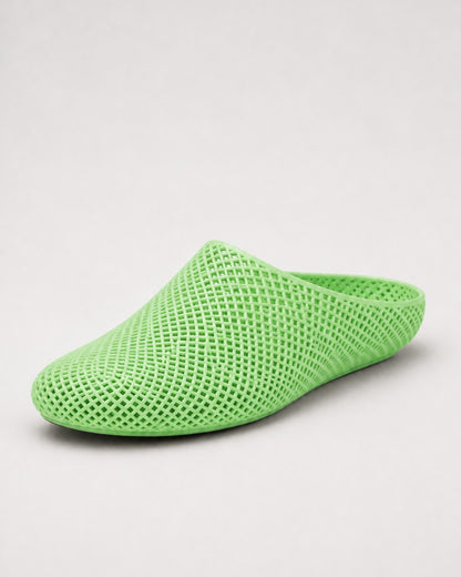 A bright lime green mesh slip-on shoe with a pointed toe and open back, shown on a light gray background.